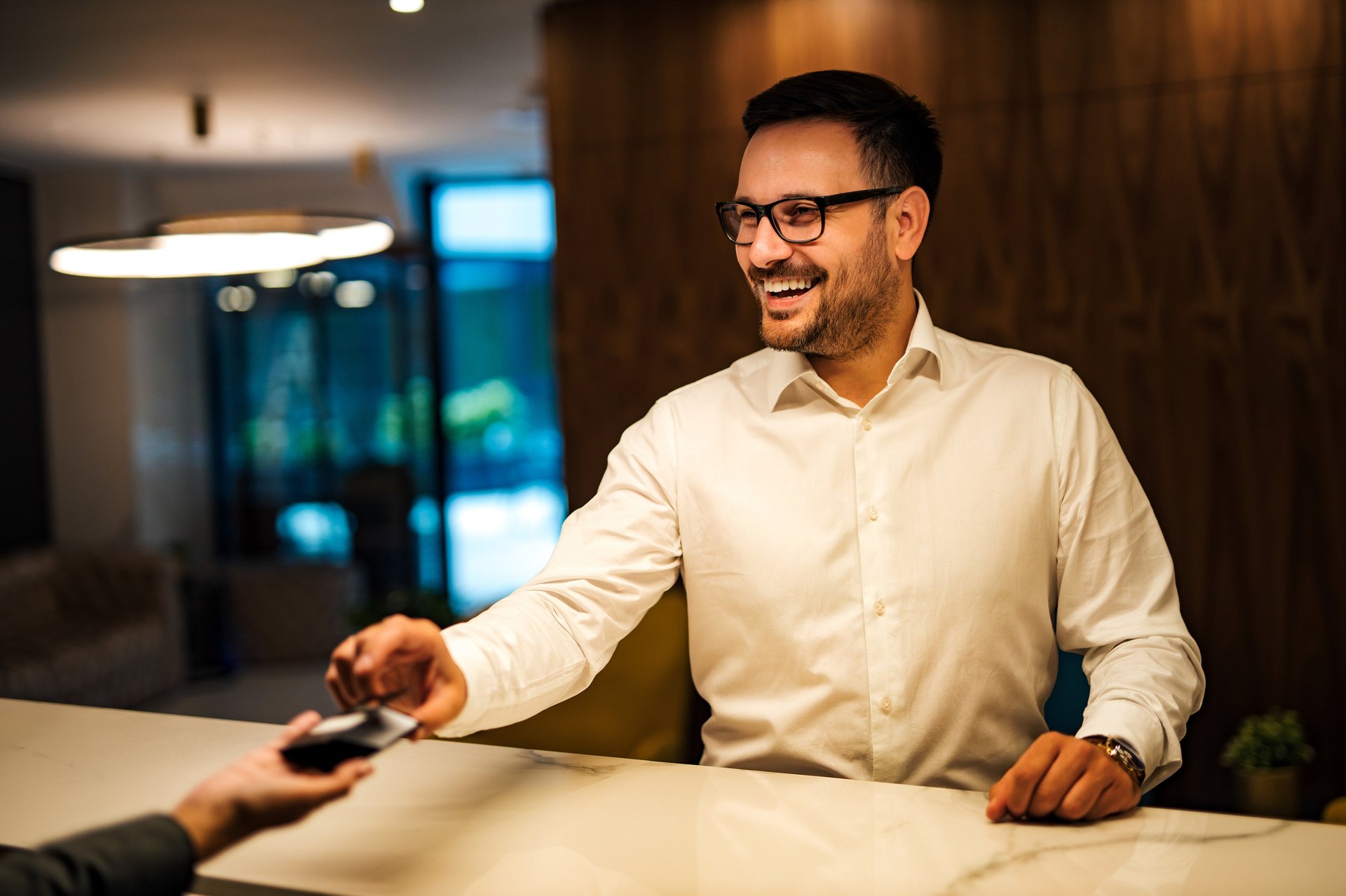 portrait-of-a-smiling-man-ringing-a-bell-at-hotel-2024-10-18-06-33-59-utc-1-1
