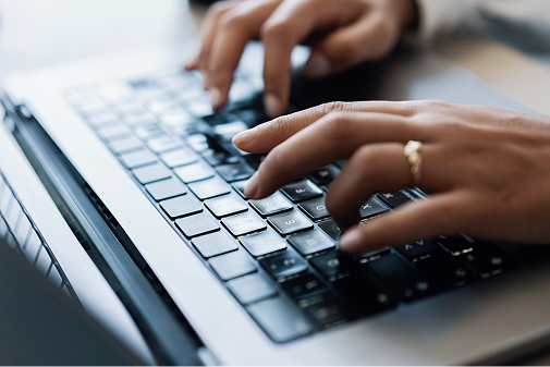 Woman writing on laptop